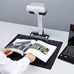person scanning a magazine using the ScanSnap SV600 overhead scanner 